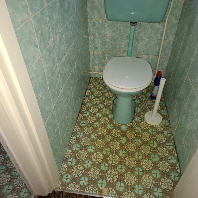 Asbestos paper lining beneath old patterned lino flooring